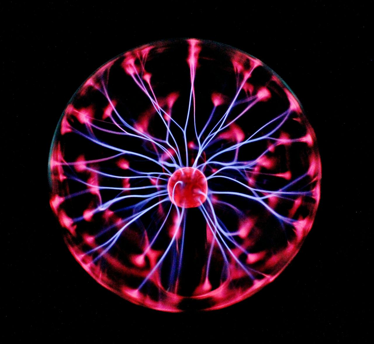 portfolio-05 Close-up of a plasma globe with vibrant neon sparks against a dark background.