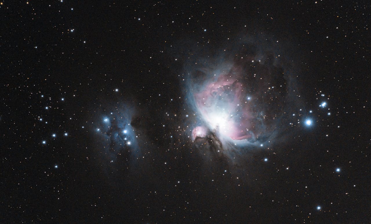 portfolio-01 Capture of the Orion Nebula (M42) with stars and galaxies in a celestial scene.